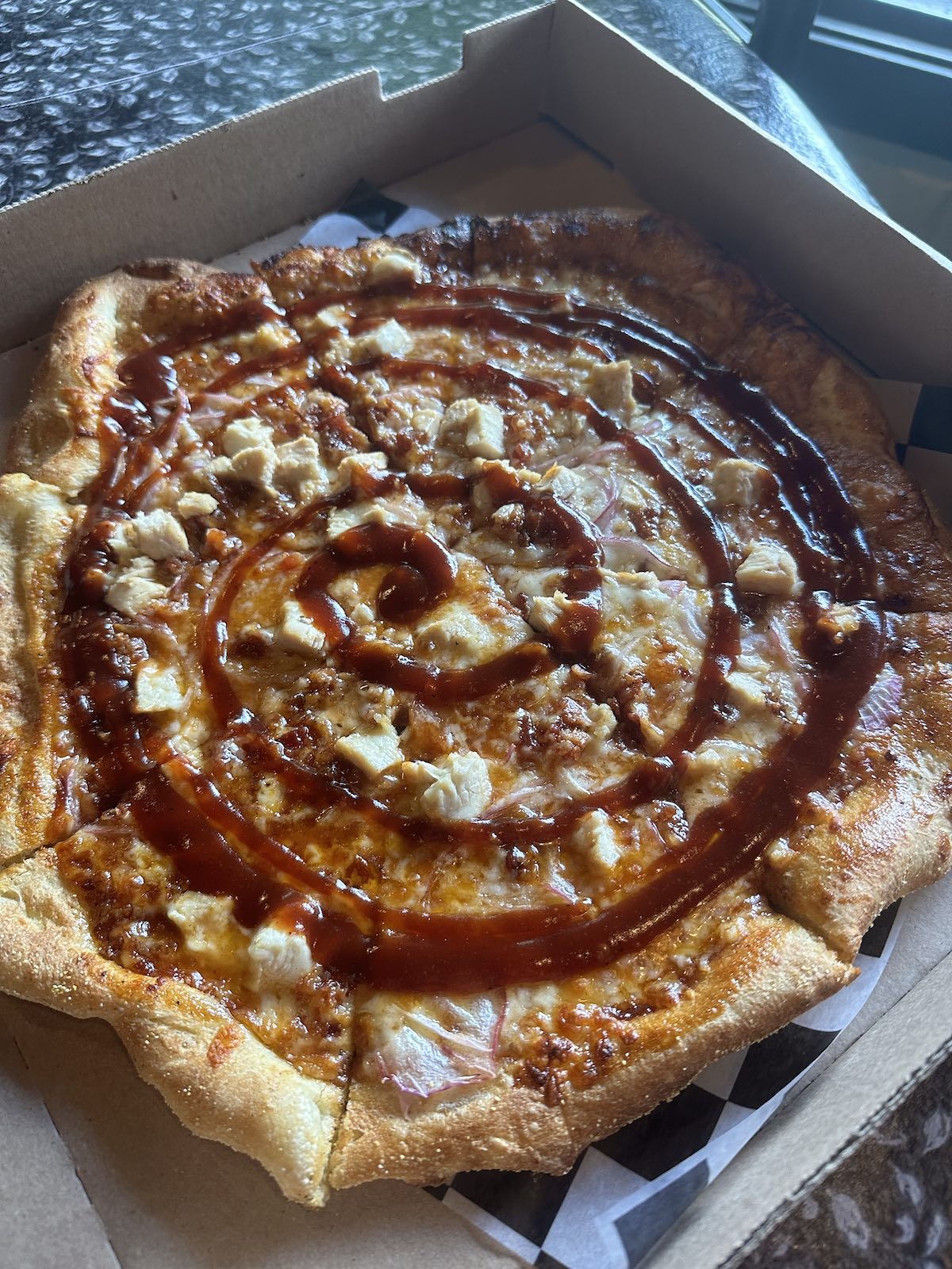 Savory BBQ Chicken Pizza with succulent chicken pieces, drizzled BBQ sauce, crispy bacon, and caramelized onions, served at The Italian Oven in Somerset, PA
