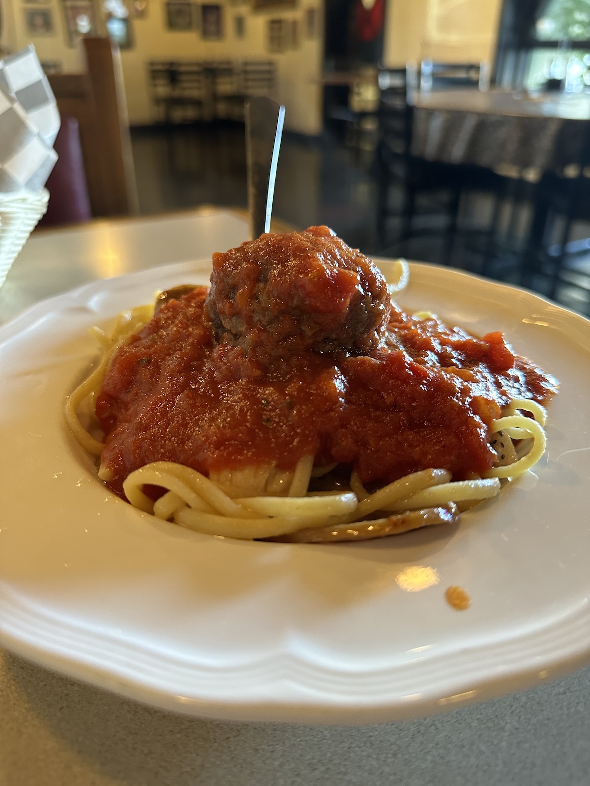 Deluxe Pasta with linguine, spicy Italian sausage, chicken, a homemade meatball, and marinara sauce, served at The Italian Oven in Somerset, PA.